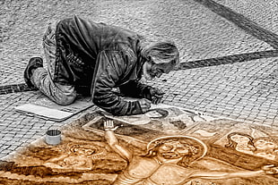 man painting religious canvass selective colored photo