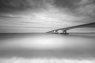 grayscale of bridge during cloudy day HD wallpaper