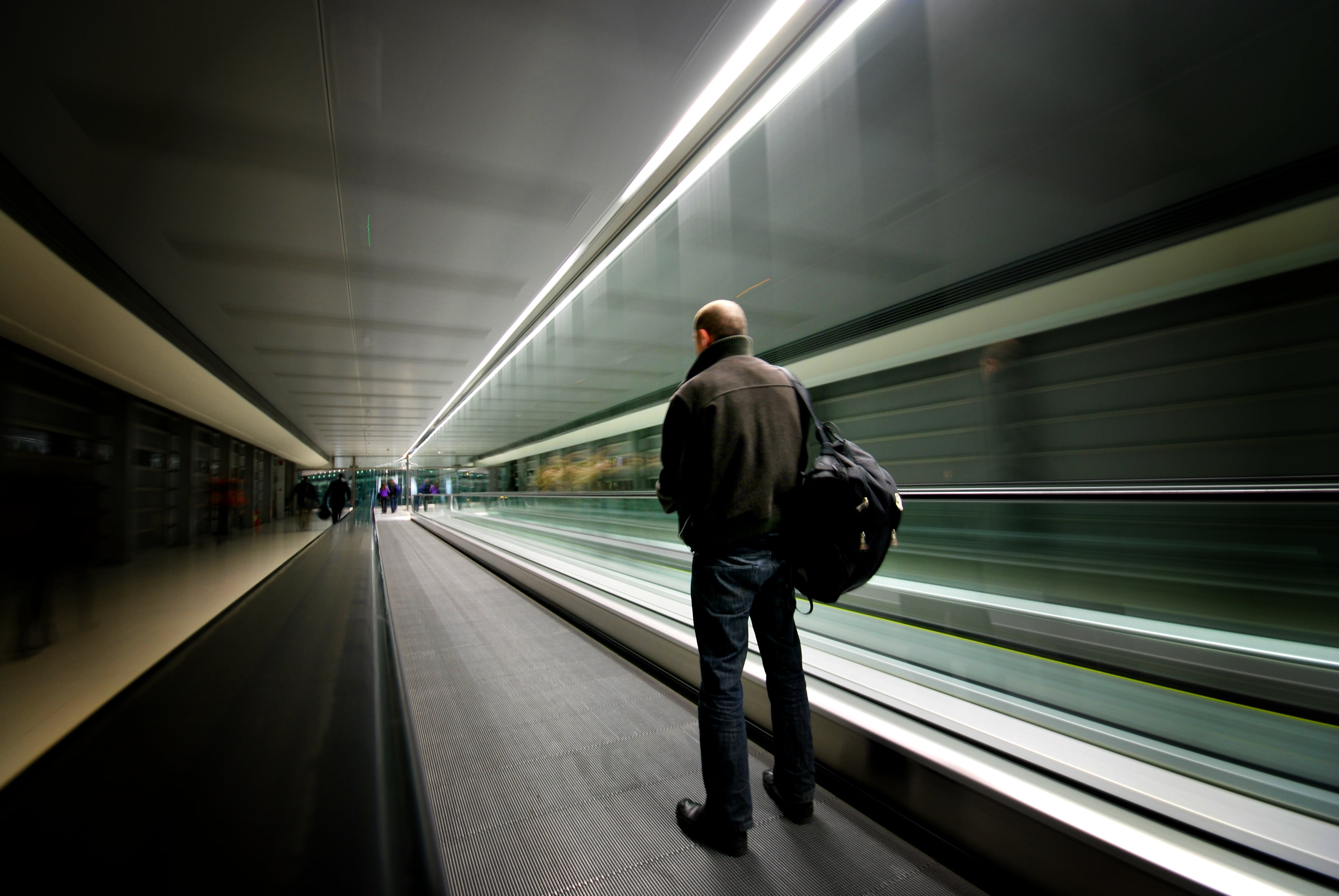 man standing holding bag