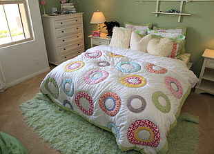 multi-colored bed comforter with pillows