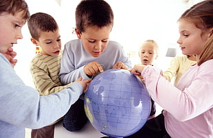 children holding desk globe