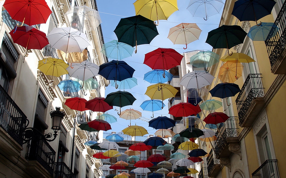 multicolored floating umbrellas during daytime HD wallpaper