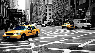 selective photo of yellow taxis in road