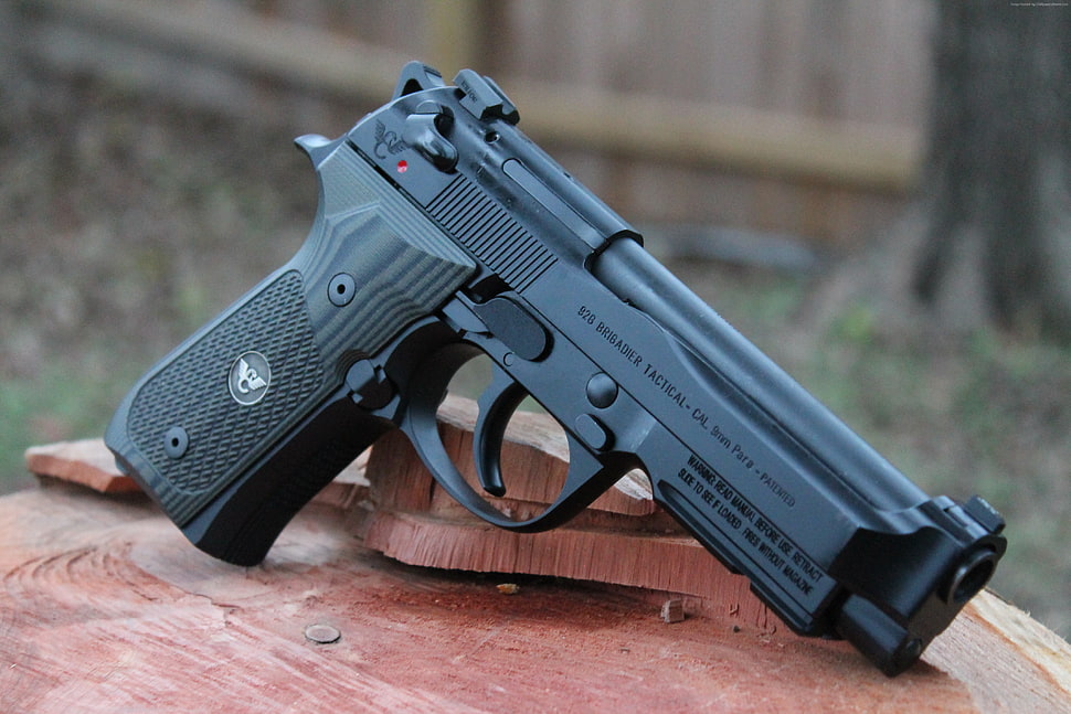 black semi-automatic pistol on brown wooden surface HD wallpaper