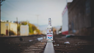 white and black labeled bottle, railway, bottles, vodka