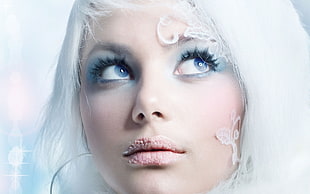 closeup photo of woman looking up with white hair