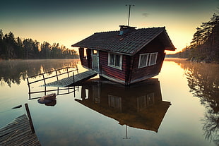 brown and black wooden house on body of water HD wallpaper