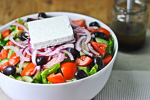 round white ceramic bowl with vegetable salad and blue cheese