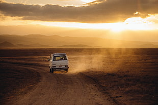 photo of white truck on desert durning golden hour