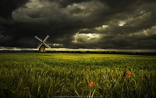 painting of grass fields near brown and gray windmill under a black and gray sky HD wallpaper