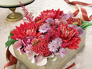 bouquet of red and pink petaled flowers with box