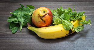 still life photography of apple fruit, banana fruit, and leaves
