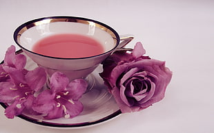 purple Rose flower and ceramic bowl in ceramic saucer on table HD wallpaper