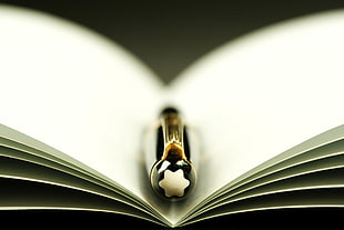 selective focus photography of black twist pen in white empty book HD wallpaper