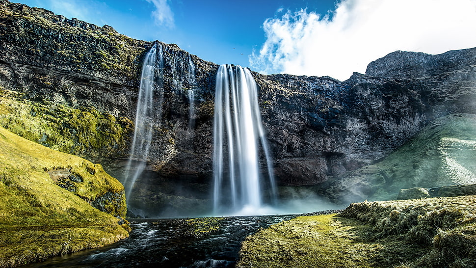 landscape photography of waterfalls under blue sky and white clouds HD wallpaper
