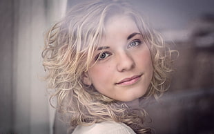 woman with blonde curly hair smiling
