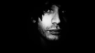 man's face in grayscale photography