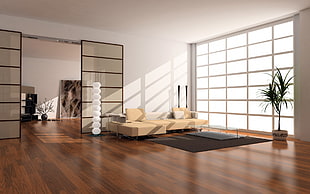 beige fabric padded sofa inside the room