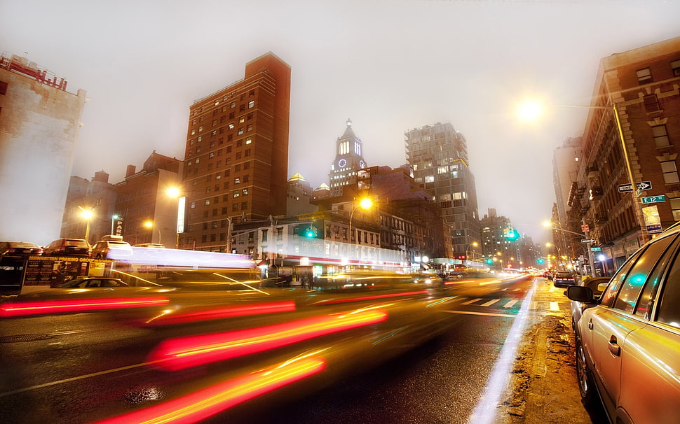 time lapse photography of road surrounded by buildings HD wallpaper