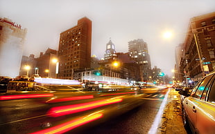 time lapse photography of road surrounded by buildings