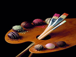 selective focus photo of truffles on brown wooden painter's block