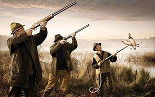 three men holding rifle while standing HD wallpaper