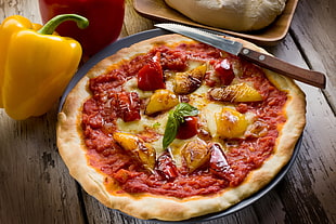 baked pizza on gray ceramic plate with brown wooden handled knife HD wallpaper