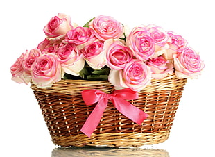 white-and-pink Roses bouquet in brown wicker basket