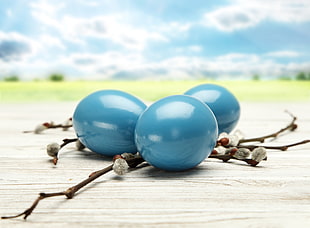 three blue pebbles in tilt-shift photography