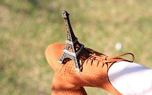 Eiffel Tower miniature on brown leather shoe HD wallpaper