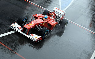 red and white F1 racing car on race track during daytime HD wallpaper