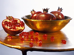 brown fruits on round gray metal bowl