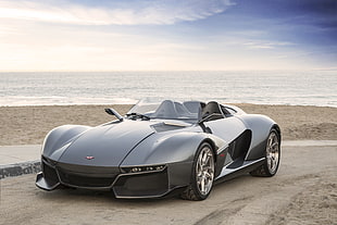 gray supercar convertible on beach during daytime