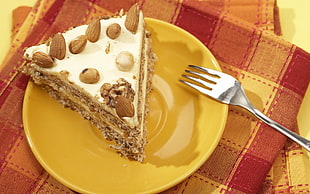 slice of pie on yellow plate with fork