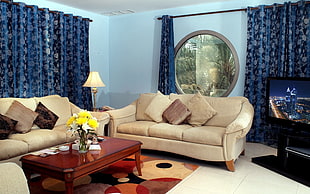 two beige sofas near brown wooden coffee table HD wallpaper