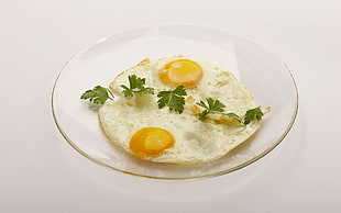 round white ceramic plate with fried egg