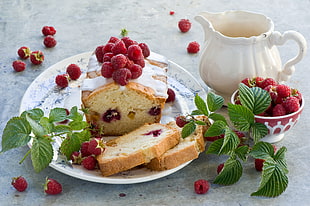 brown loaf bread with white cream and berries on top