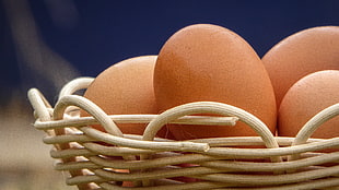 beige eggs on beige wooden wicker basket