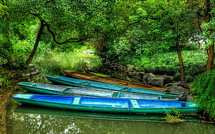 three green and one brown canoes