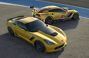 yellow Corvette C7 beside yellow and black sports car parked on concrete road