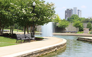 two black benches in front of water fountain