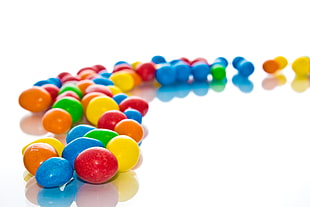 assorted colored candies on white surface