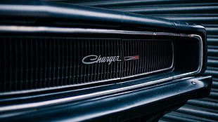 black Dodge Charger grille near metal door