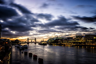 silhouette photo of high-rise building beside body of water, tower bridge HD wallpaper
