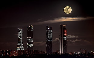 four skyscraper buildings, city, night