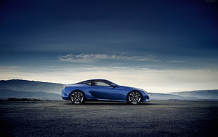 blue sports coupe on black top road during daytime