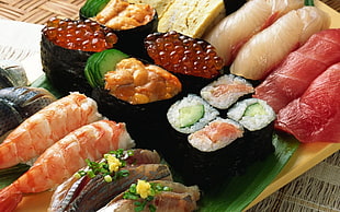 bunch of sushi on brown tray