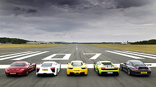 five red, white, yellow, green, and black stock cars, transport, car