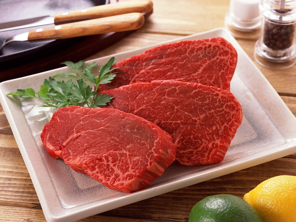 three sliced meats with green leaf on white plate HD wallpaper