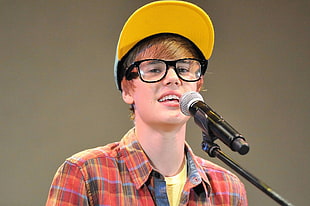 Justine Bieber infront of microphone